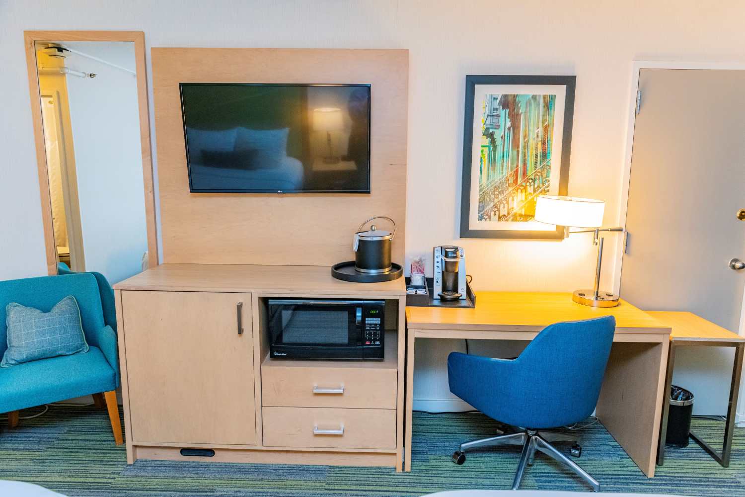 Guest room with a work desk, a TV, and a microwave