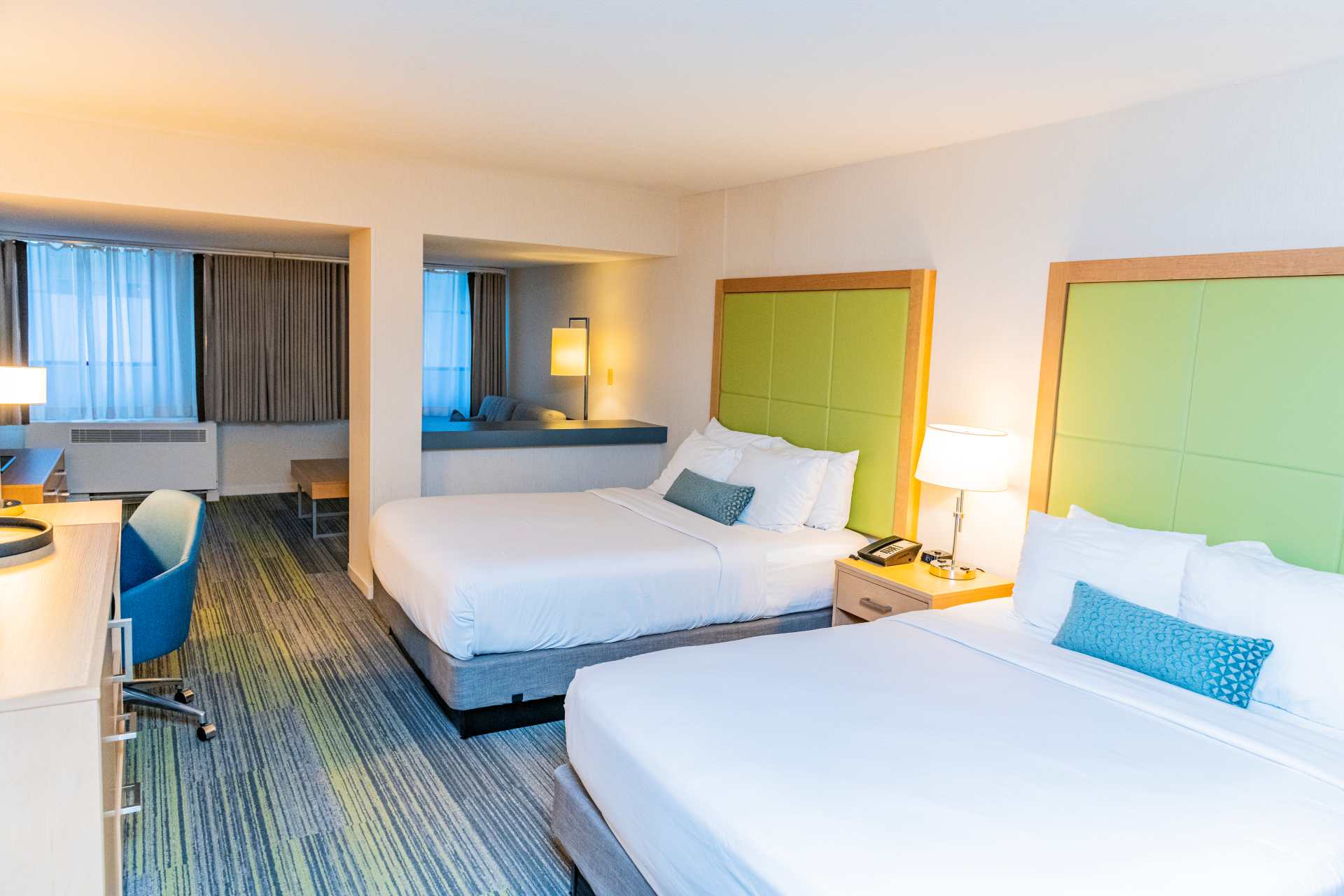 Guest suite with two queen beds and a desk
